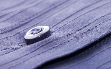 Close Up of Button on Purple Garment